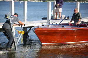 A picture of men loading a boat from the lake onto a trailer